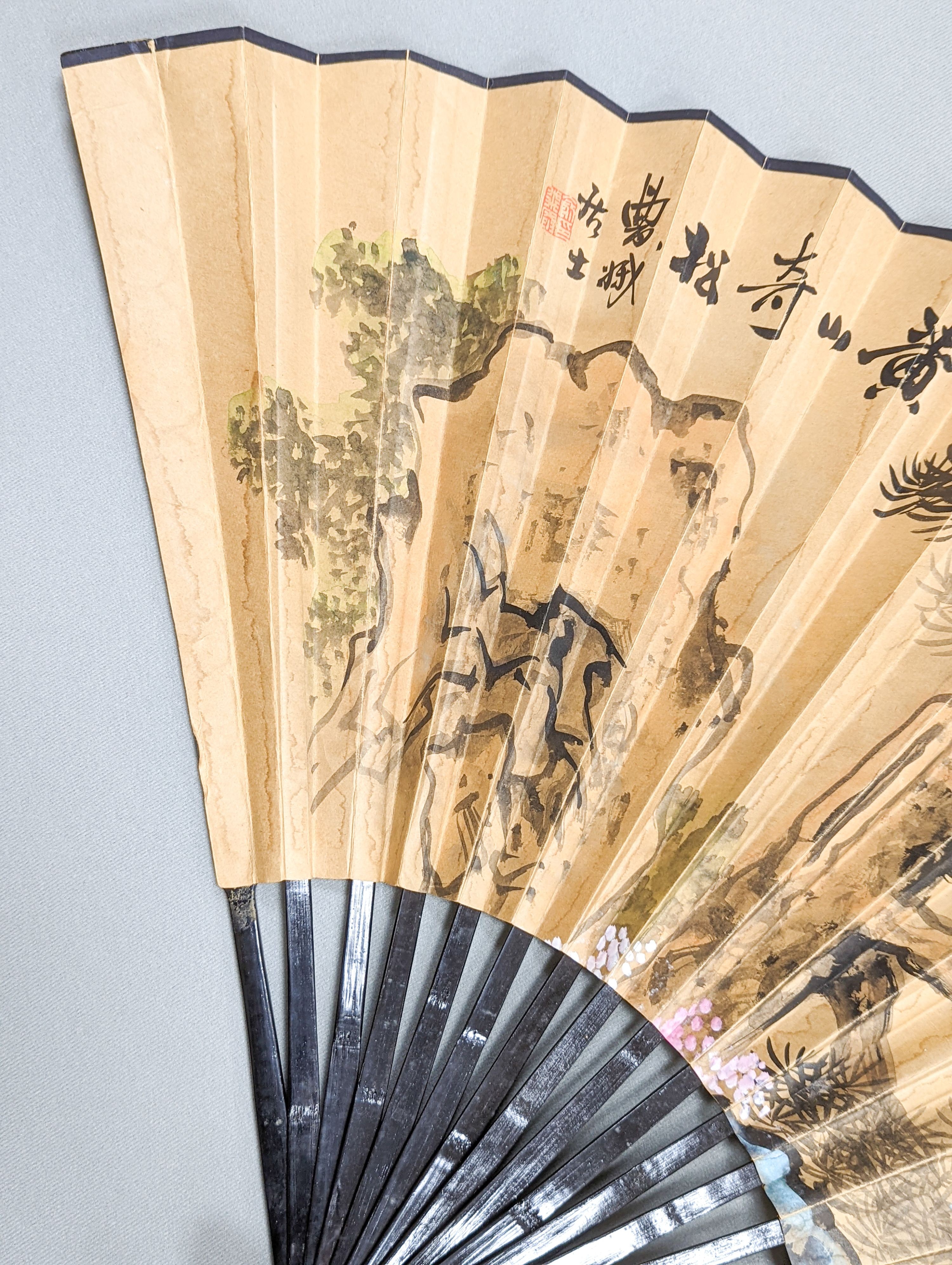 A large Chinese fan, the leaf painted with a landscape, signed Radius 60cm